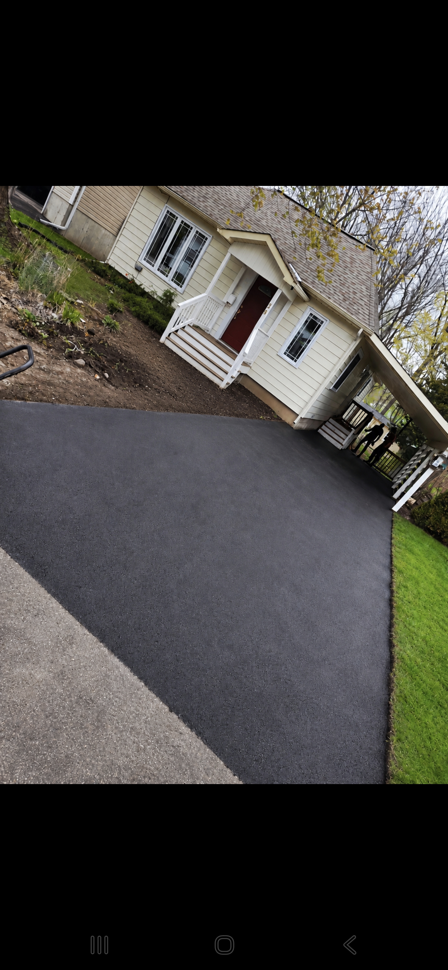 Freshly sealed residential driveway — dark, crisp finish