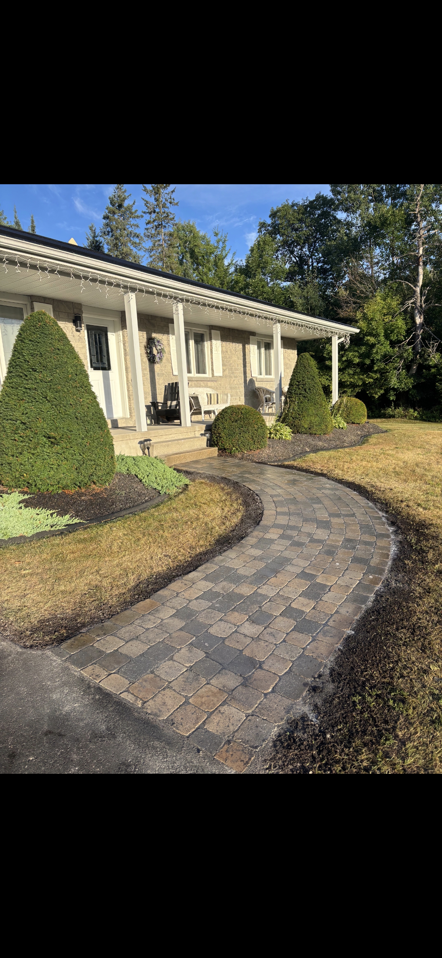 Interlock stone walkway with clean landscaped borders