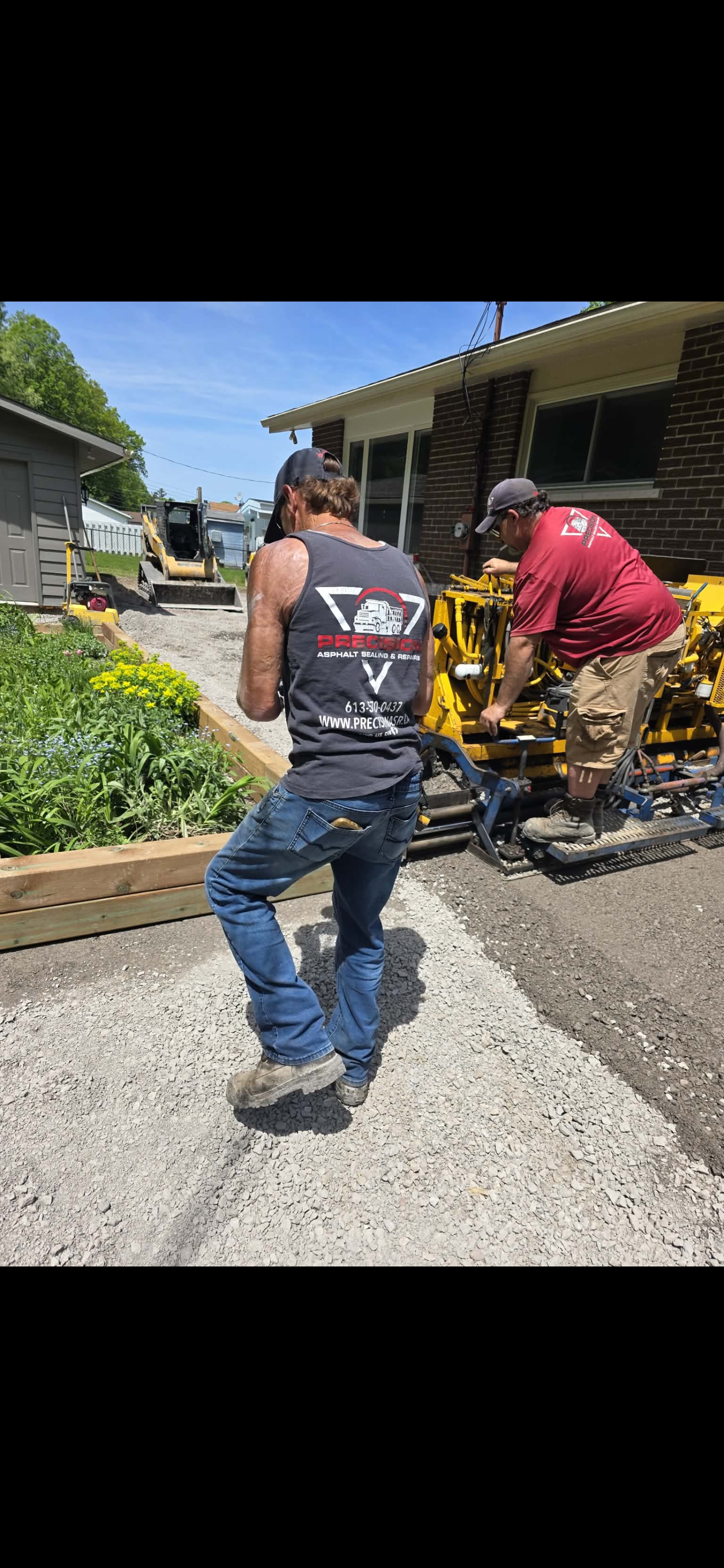 Precision crew on-site paving a residential driveway