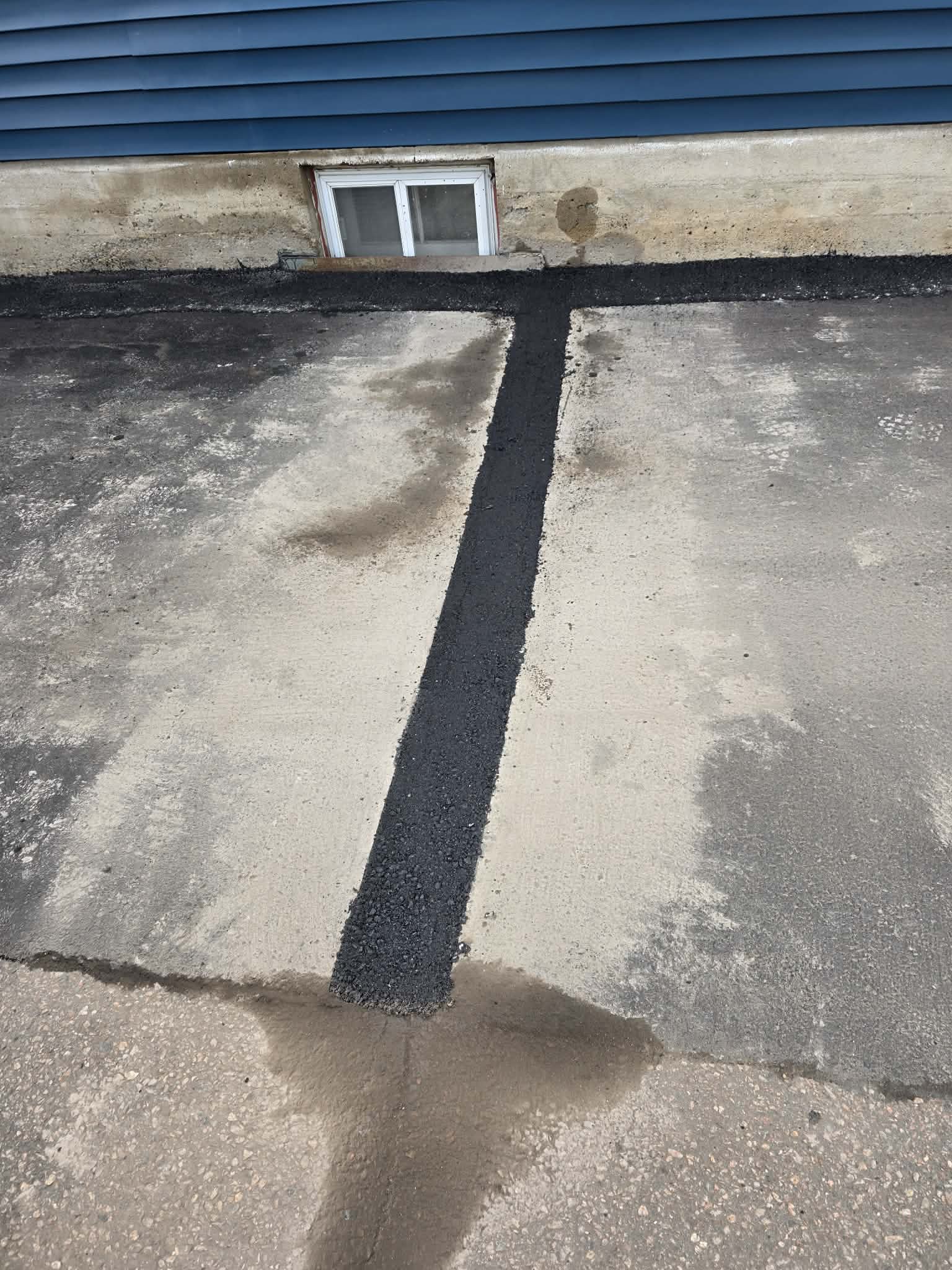 Hot-rubber crack fill across a concrete slab joint
