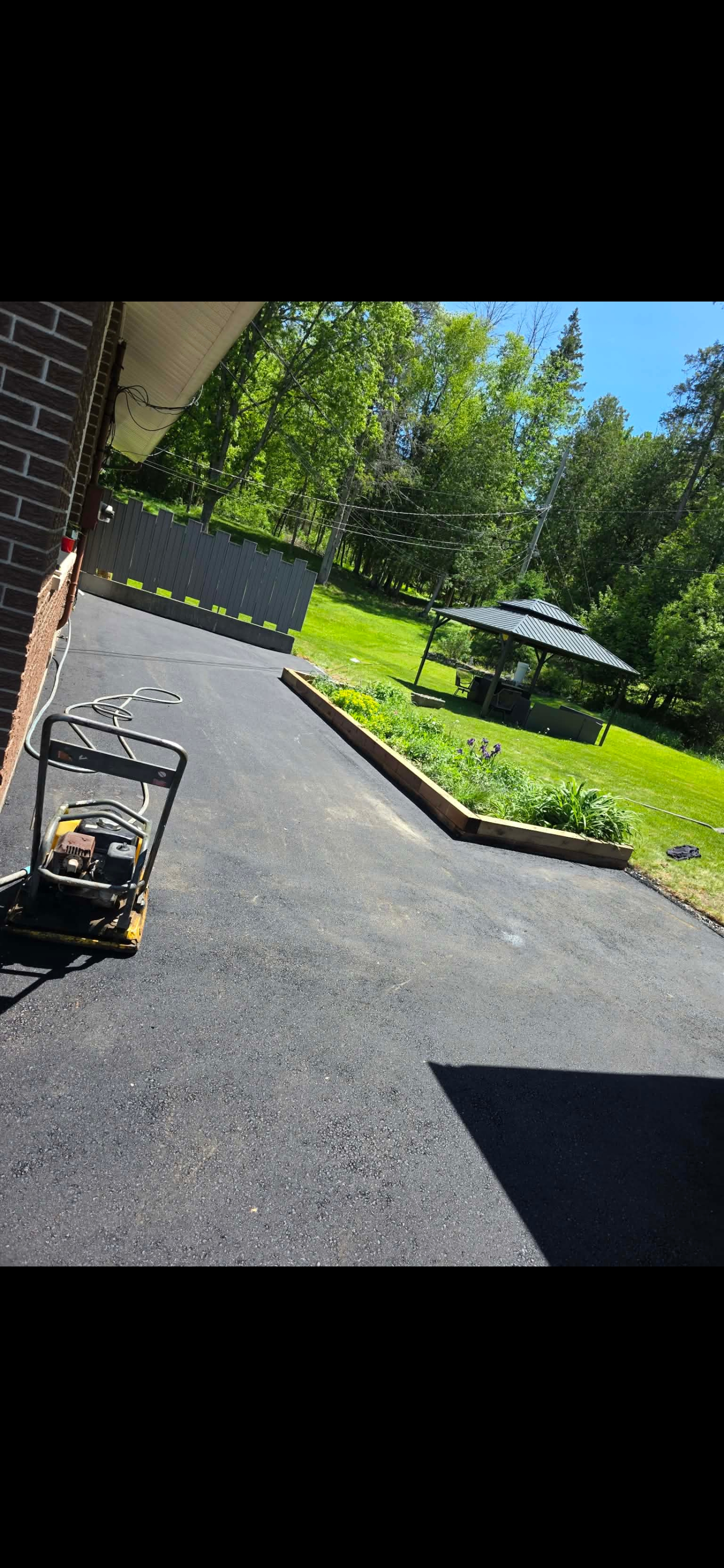 Compacting a new residential driveway install