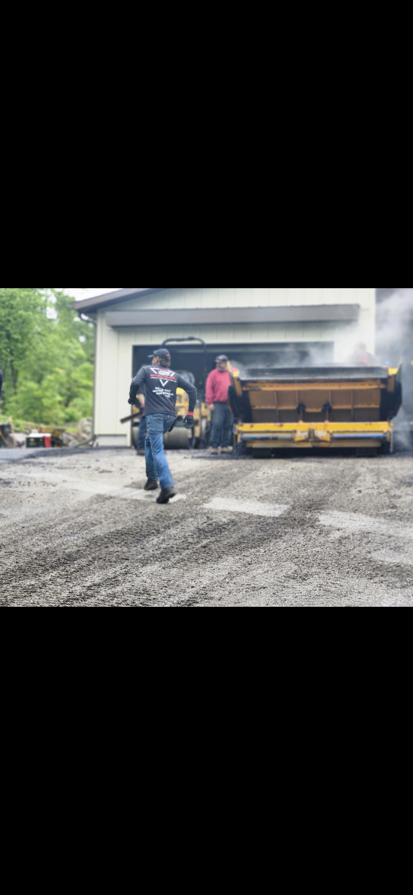 Paver machine laying commercial-grade asphalt